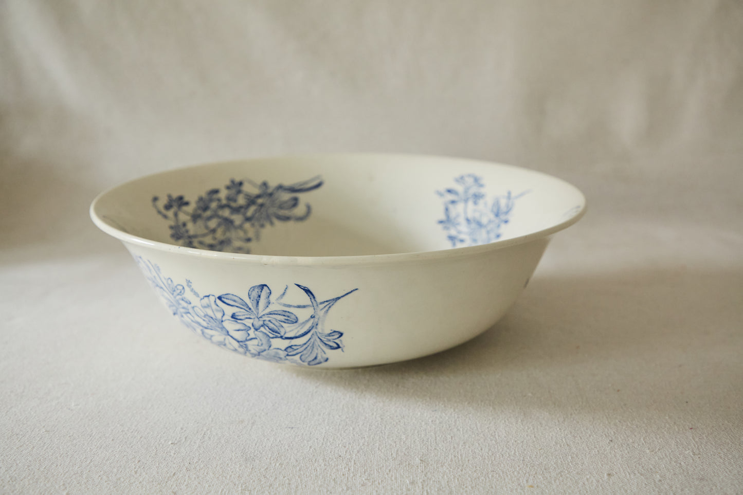 Large white ceramic wash bowl with blue flower print