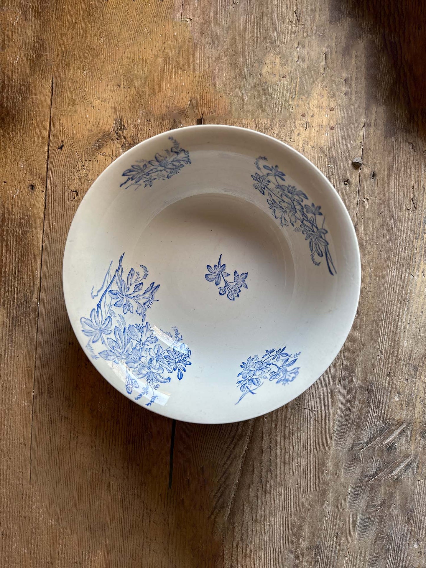 Large white ceramic wash bowl with blue flower print